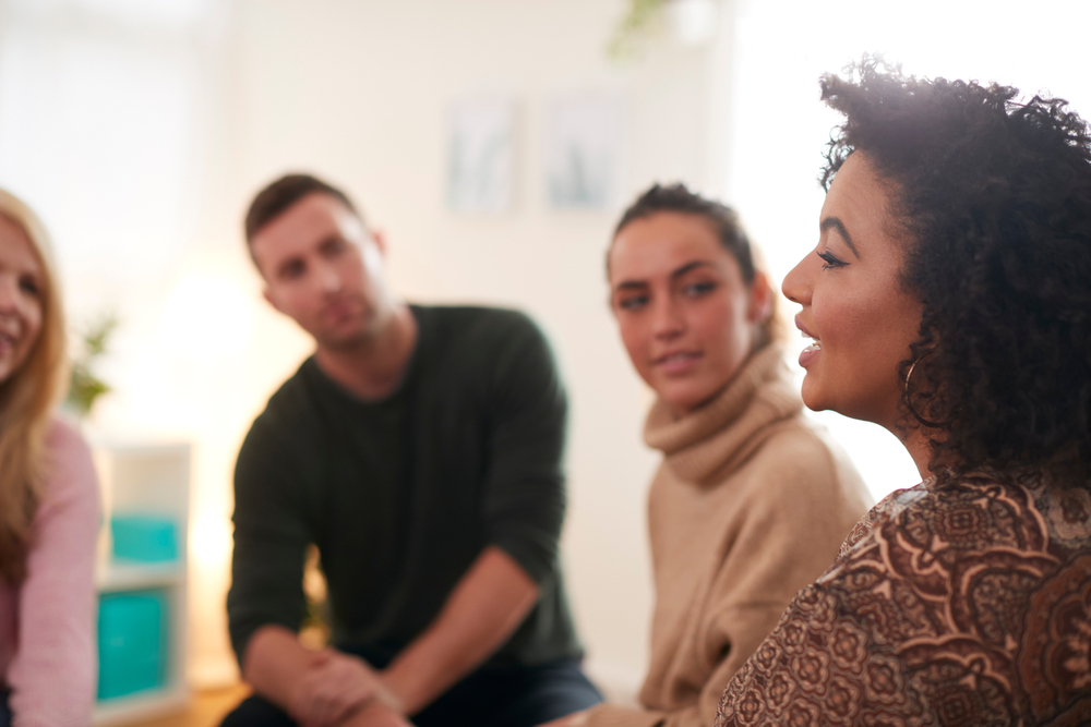 woman speaking at support group meeting